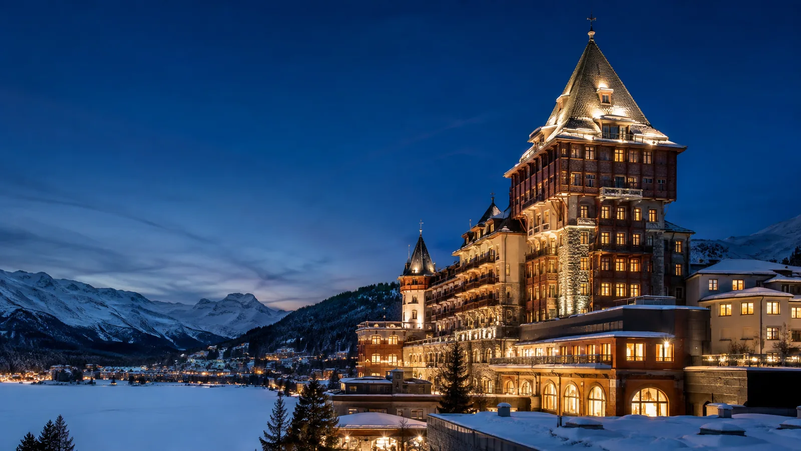 Editorial blue-hour exterior view inspired by Badrutt’s Palace Hotel in St. Moritz