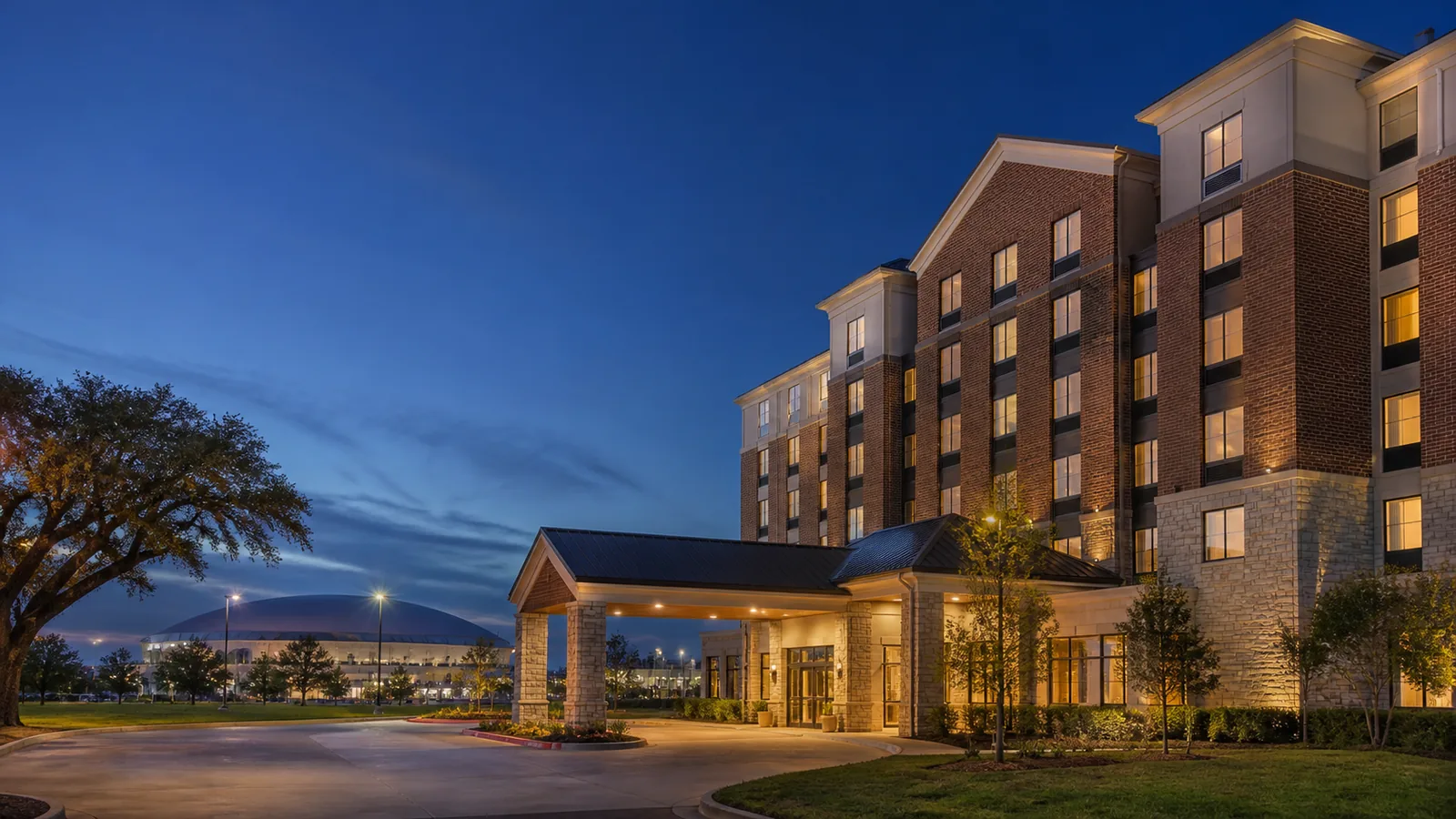 Editorial blue-hour exterior view inspired by Hilton Garden Inn Lafayette/Cajundome in Lafayette