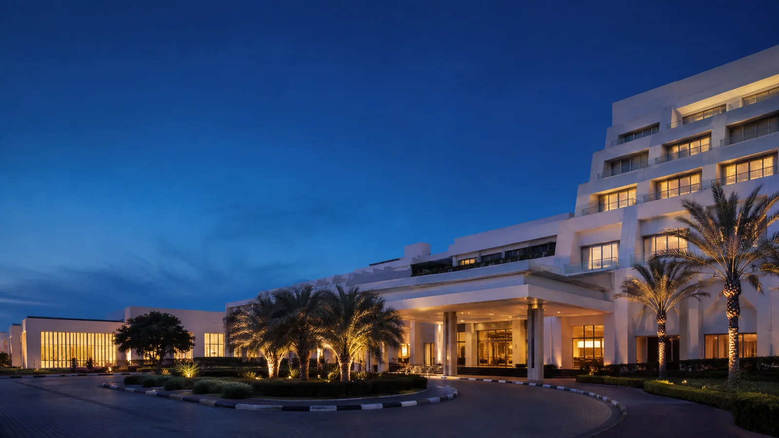 Editorial blue-hour exterior view inspired by Le Méridien Dubai Hotel & Conference Centre in Dubai
