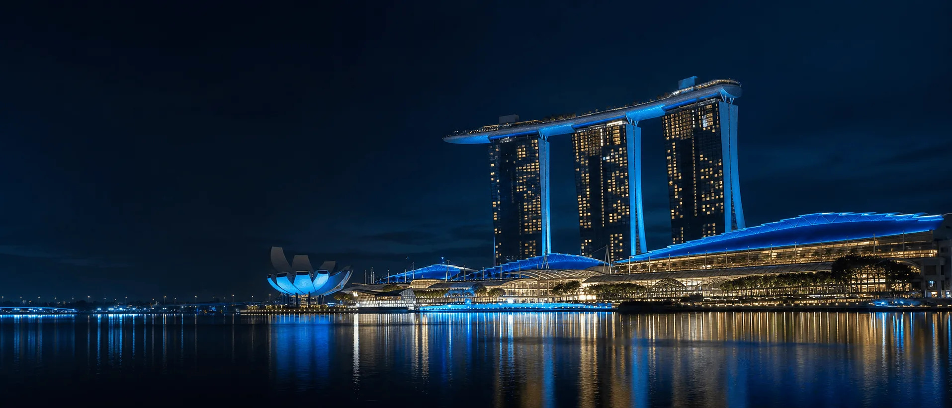 Marina Bay Sands illuminated over Singapore's bay at night