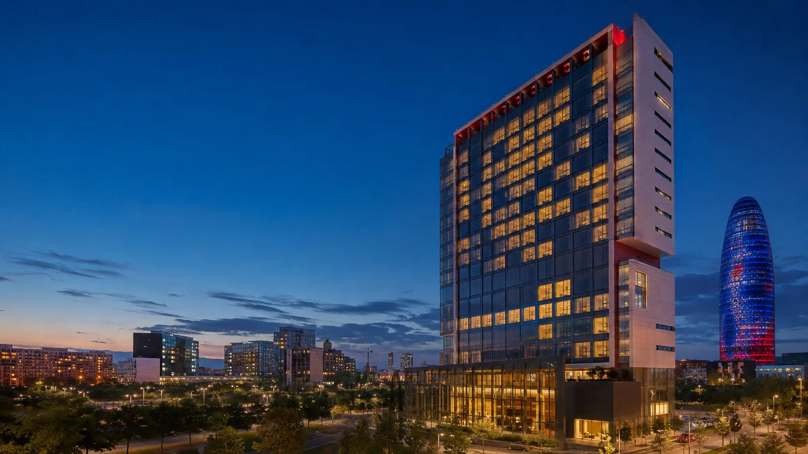 Editorial blue-hour exterior view inspired by Novotel Barcelona City in Barcelona