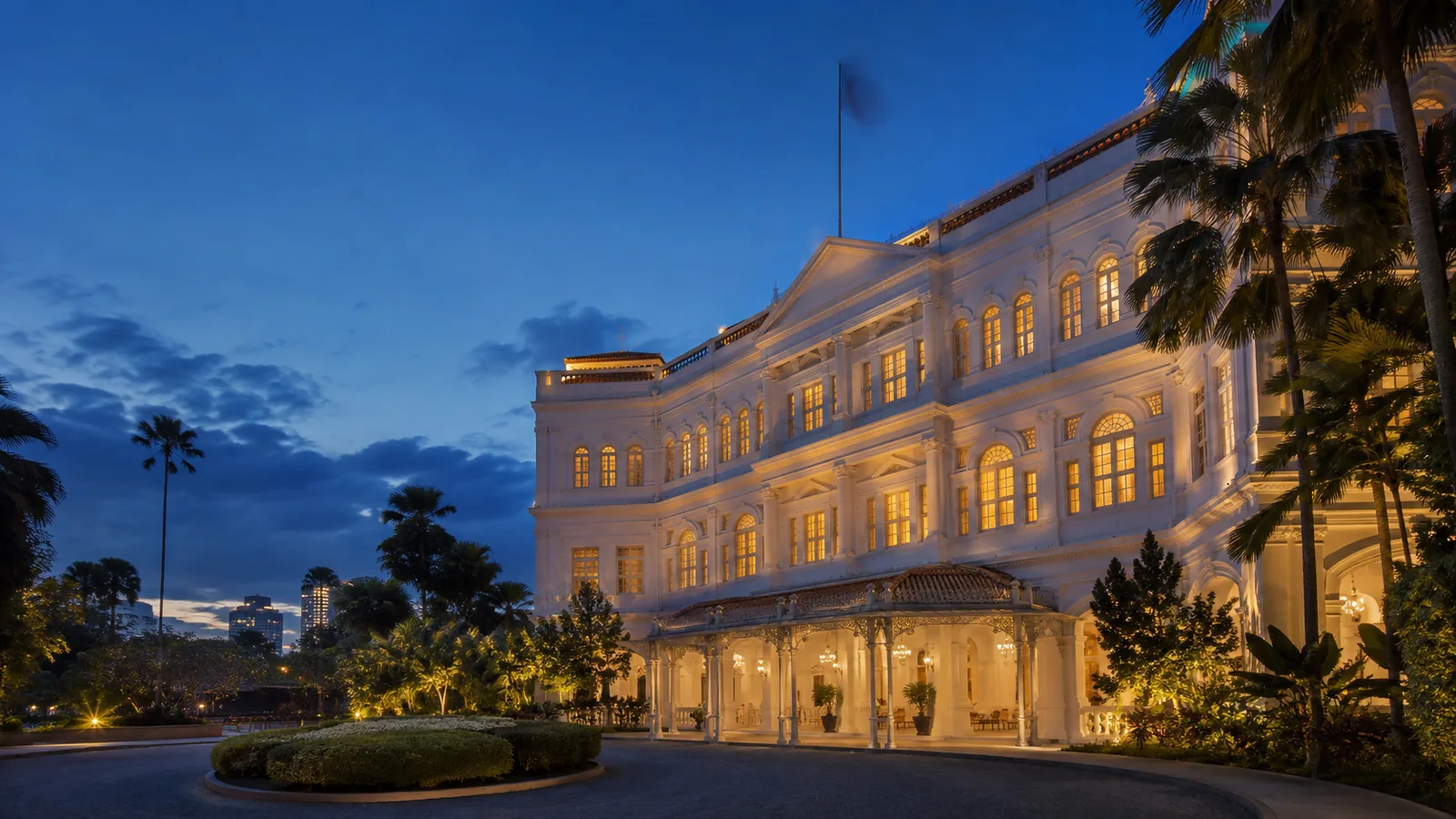Editorial blue-hour exterior view inspired by Raffles Hotel Singapore in Singapore